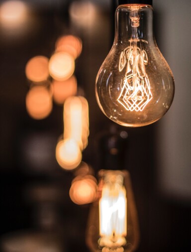 Incandescent bulb with soft focus lights in the background