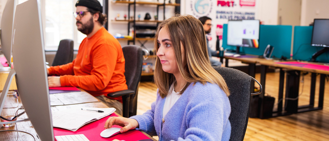 Abi Suttle, graphic designer, at her desk at This is Fever's studio in Colchester