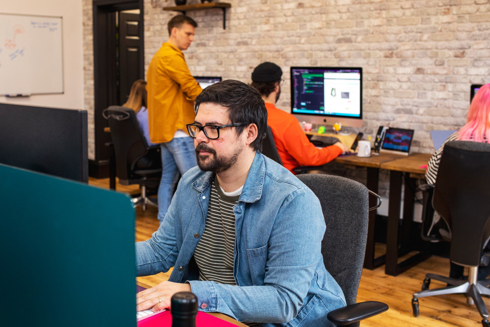 Designer with a developer and project manager behind him.