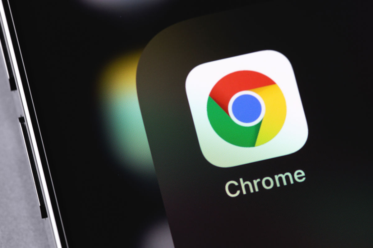 Close up of a smartphone with the Chrome app displayed on the screen.