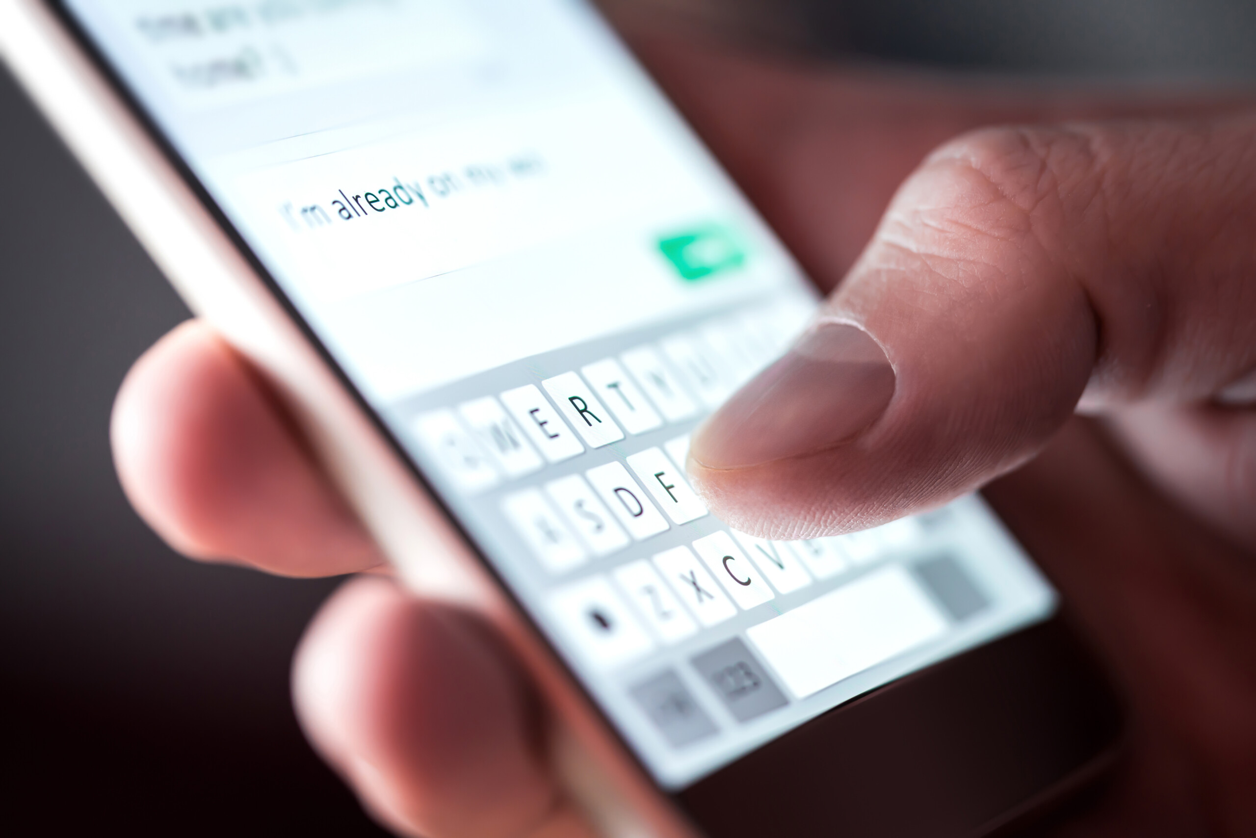 Man sending text message with smartphone