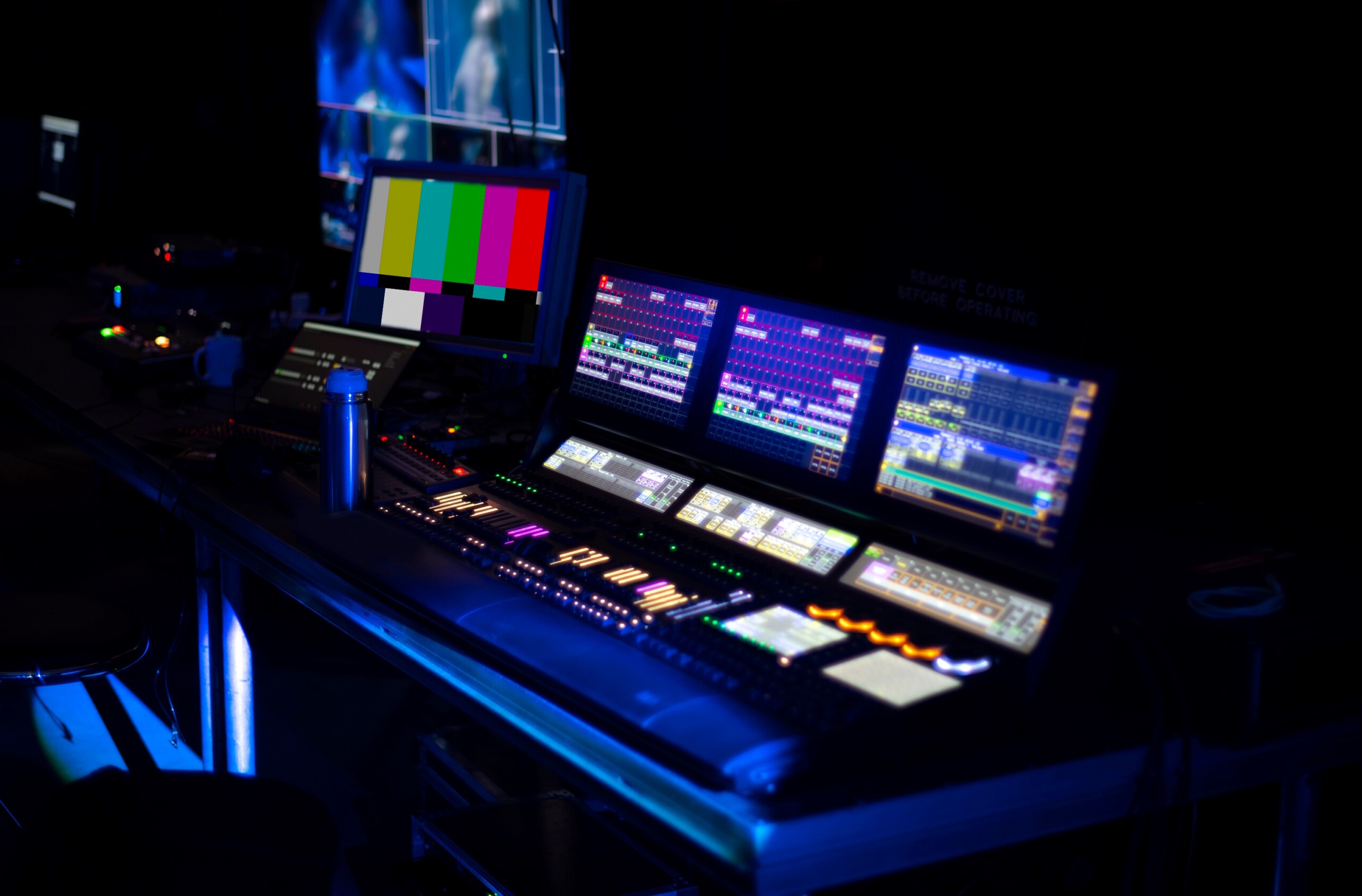 Screens and controls set up for the behind the scenes of a virtual event.